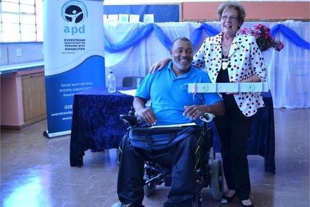 Executive Mayor, Nicolette Botha-Guthrie, proudly showing off the handmade gift presented to her by OAPD's Co-ordinator Peer Support, Lionel Isaacs